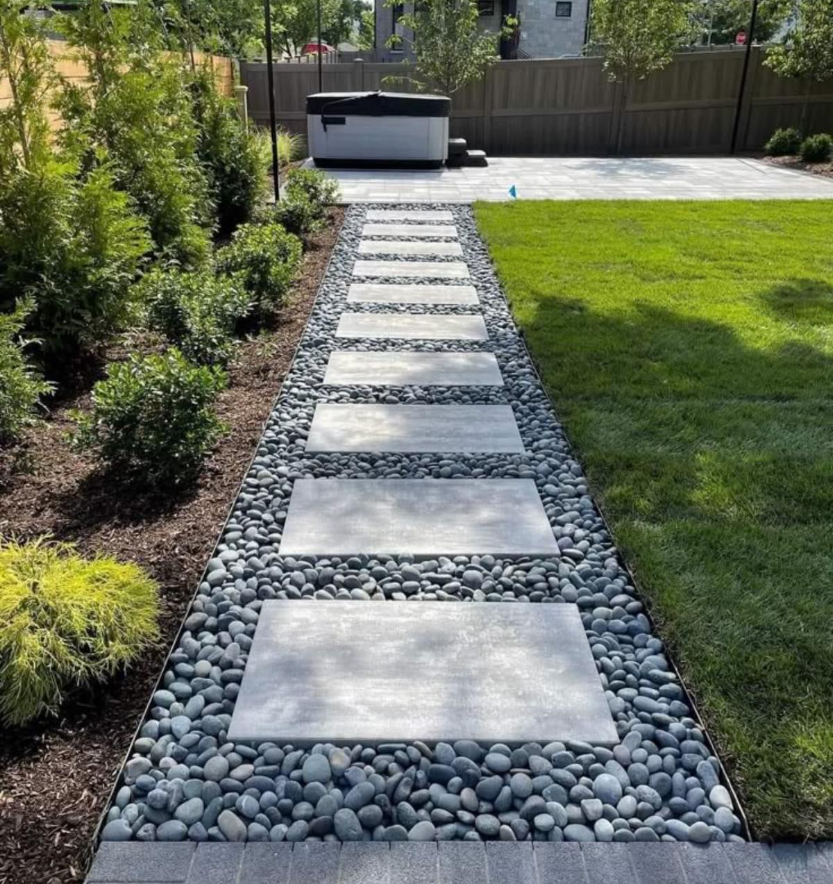Stone pathway bordered by trimmed landscaping